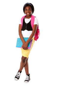 Beautiful happy student girl with colorful notebooks and backpack ready for school, isolated.