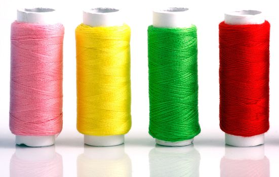 Set of colorful spools of thread isolated on white background