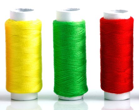 Set of colorful spools of thread isolated on white background