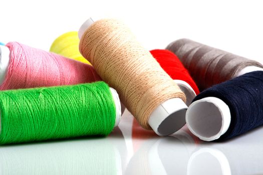 Set of colorful spools of thread isolated on white background