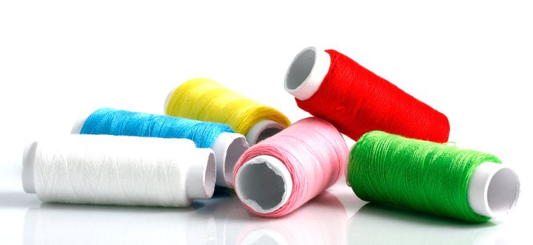 Set of colorful spools of thread isolated on white background