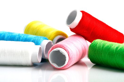 Set of colorful spools of thread isolated on white background