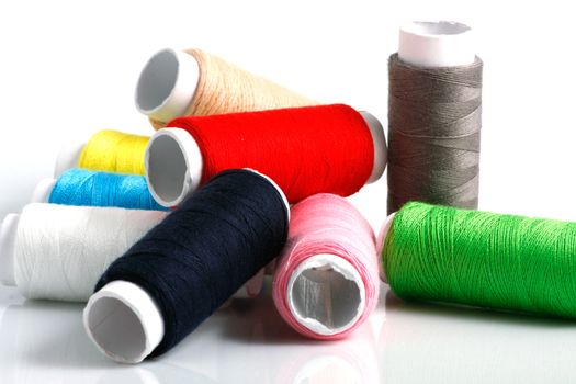 Set of colorful spools of thread isolated on white background