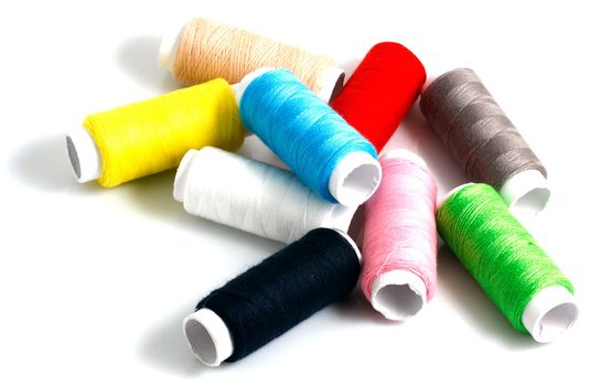 Set of colorful spools of thread isolated on white background