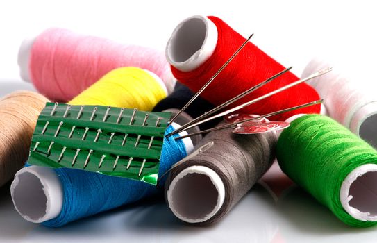 Set of colorful spools of thread isolated on white background