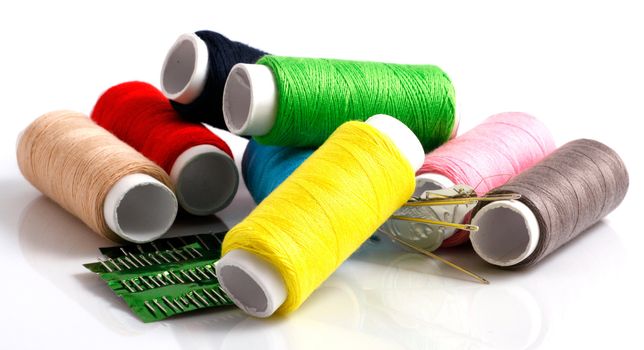 Set of colorful spools of thread isolated on white background