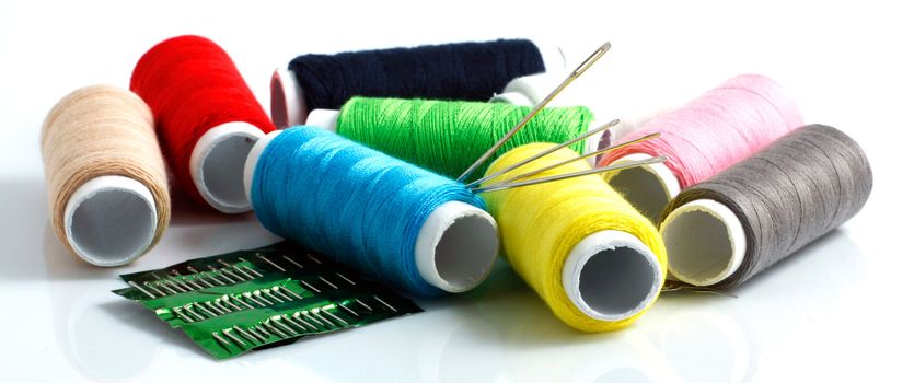 Set of colorful spools of thread isolated on white background