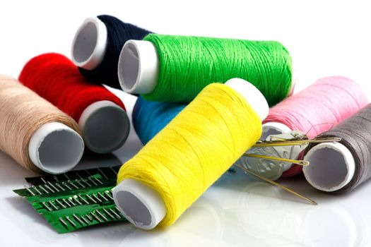 Set of colorful spools of thread isolated on white background