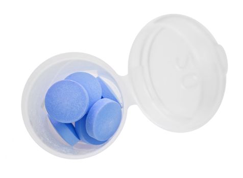 Blue pills and pill bottle on white  background with space for text
