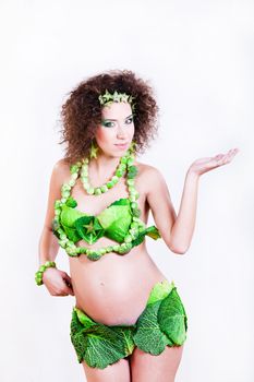 beautiful pregnant young woman dressed in cabbage