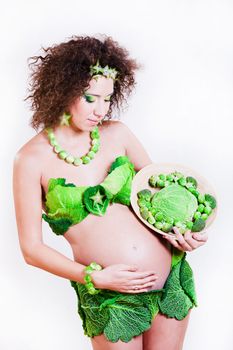 beautiful pregnant young woman dressed in cabbage