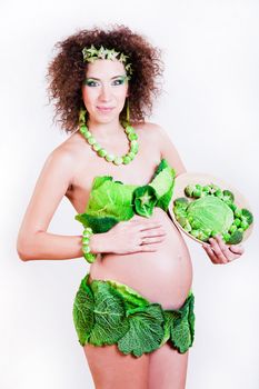 beautiful pregnant young woman dressed in cabbage