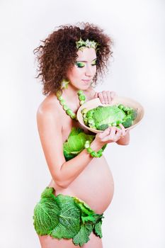 beautiful pregnant young woman dressed in cabbage