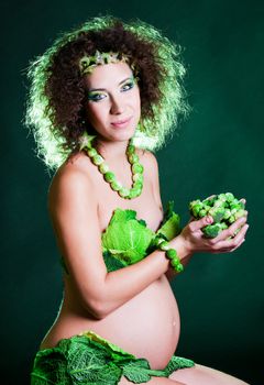 beautiful pregnant young woman dressed in cabbage