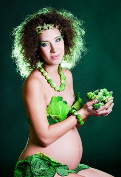 beautiful pregnant young woman dressed in cabbage