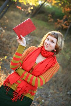 portrait of a girl in a bright colored striped sweater lying on the grass