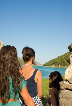 Three friends enjoying an outlook on a lake