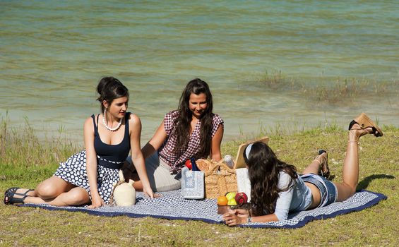 Girls enjoying a pleasant spring time picnic
