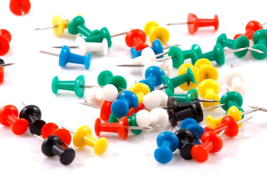 Collection of various pushpins on white background