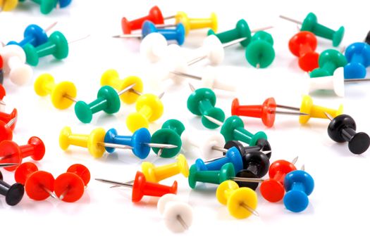 Collection of various pushpins on white background