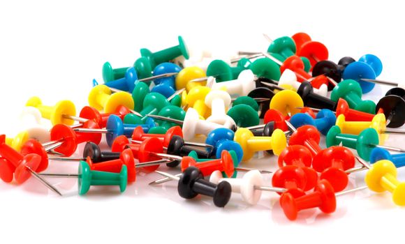 Collection of various pushpins on white background