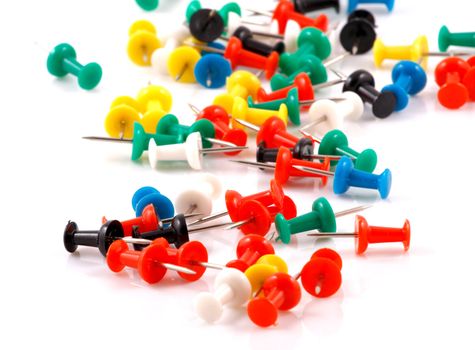 Collection of various pushpins on white background