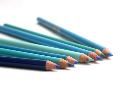 Coloring pencils of blue hues on white background