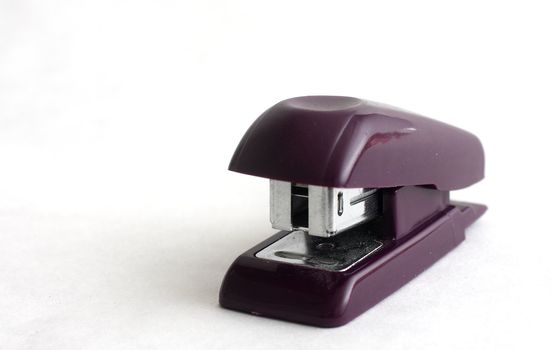 isolated shot of a small black stapler on white