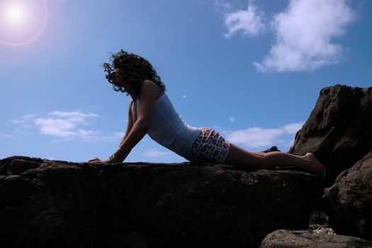 a beautiful woman doing yoga to show a healthy way to live a happy and relaxed lifestyle in a world full of stress