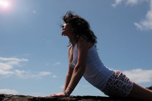 a beautiful woman doing yoga to show a healthy way to live a happy and relaxed lifestyle in a world full of stress