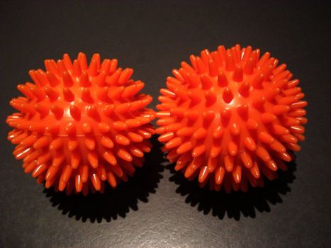 two massage balls on dark background