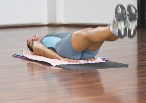 Young woman doing floor aerobics in a gym.Shot with Canon 70-200mm f/2.8L IS USM