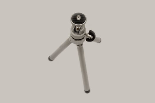 small tripod isolated on grey
