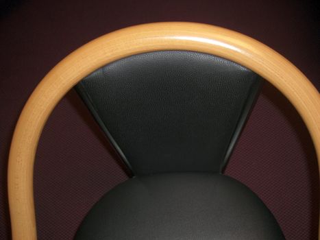 Black chair with wooden armrest