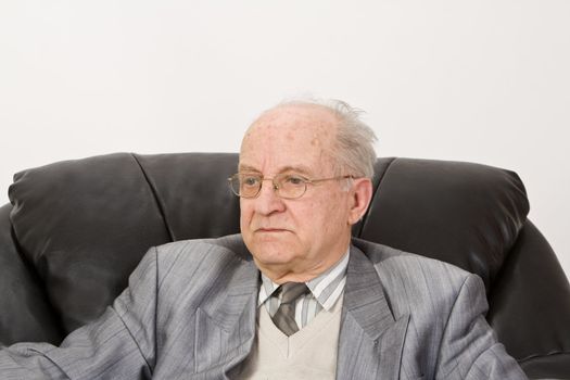 Portrait of a senior businessman against a white background.