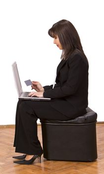 Woman doing an online credit card purchase in a waiting room.