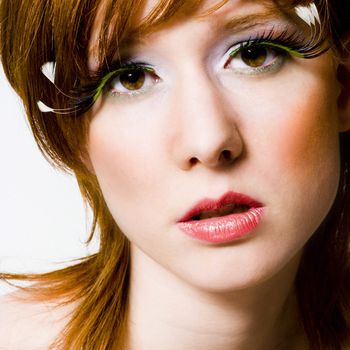 Portrait of a red haired girl with extreme make-up