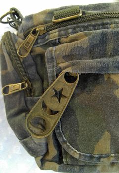 detail of an handbag in military style, used look