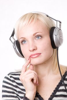 a pensive girl in headphones listening music