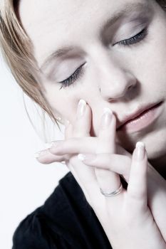 Studio portrait of young girl with reddish hair looking depressed
