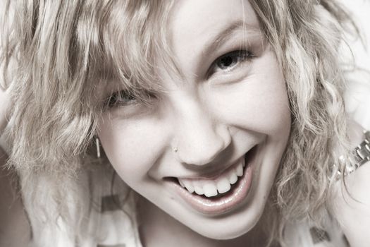 Studio portrait of a curly blond female