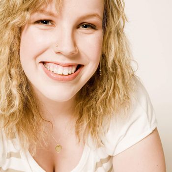 Studio portrait of a curly blond female