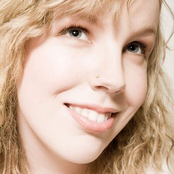 Studio portrait of a curly blond female