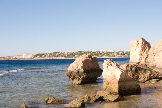 a view to the hotel line of the Red Sea through the rocks and sea