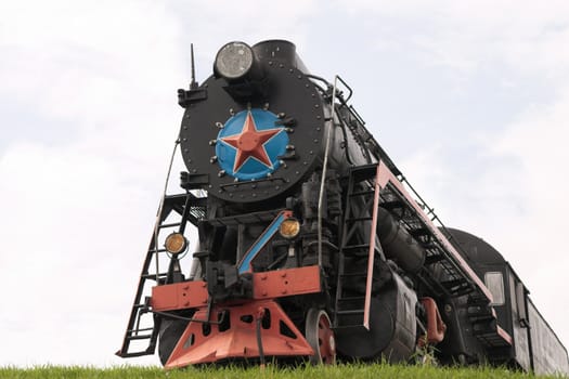 Old restored steam locomotive on a pedestal