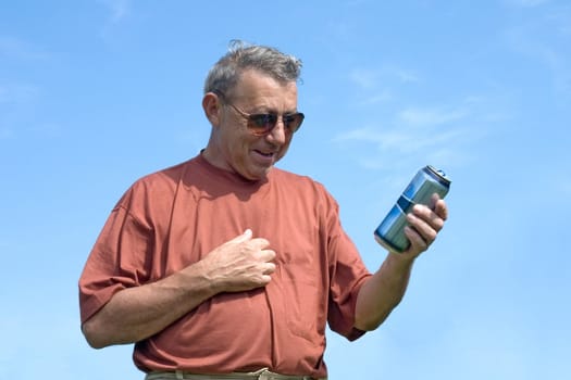 The man with a jar of beer on a background of the blue sky