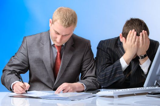 Two young attractive business men working in office