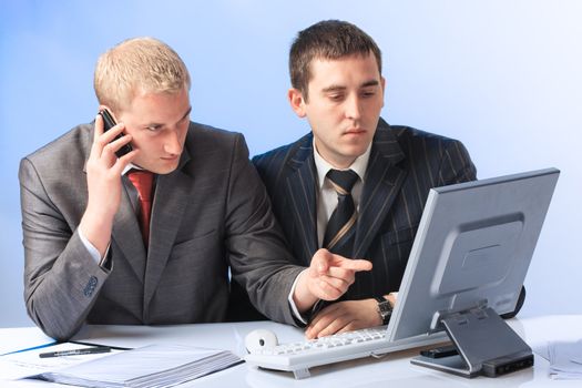 Two young attractive business men working in office