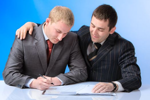 Two young attractive business men working in office