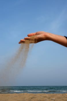 sand running through hands as a symbol for time running, lost etc.............